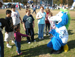 Two-year-old Tannon Rogers plays catch with Blue, the mascot for the Indianapolis Colts, at the Rittertown Fall Festival on Nov. 1. Sponsors of the event included Cargill Inc., Clarian, ClearChannel Outdoor, Coca-Cola, Dawson&rsquo;s on Main, Diversified Business Systems, the Indianaplis Colts, The&nbsp;Indianapolis Star, Promotions Resources and Target. (Photo by Mike Krokos) 