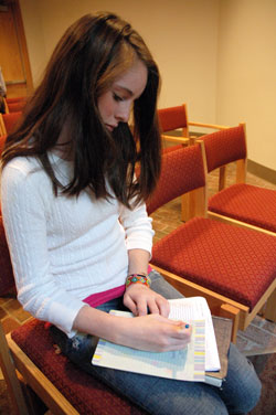 St. Thomas Aquinas parishioner Katie Quigley of Indianapolis writes a letter to Indiana Sen. Evan Bayh asking for his support of global hunger relief legislation during Bread for the World&rsquo;s Offering of Letters on Oct. 26 at the Indianapolis North Deanery church. St.&nbsp;Thomas Aquinas parishioners and members of several Protestant Churches in Indianapolis will be featured in the organization&rsquo;s 2009&nbsp;educational video, which will be distributed to thousands of churches in the U.S., sent to every member of Congress and posted on Bread for the World&rsquo;s Web site. (Photo by Mary Ann Wyand) 