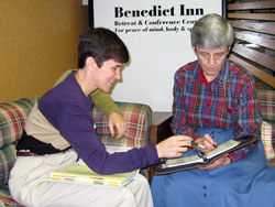 Benedictine Sister Sheila Marie Fitzpatrick, left, a member of Our Lady of Grace Monastery in Beech&nbsp;Grove, talks with Benedictine Sister Carol Falkner, prioress, about scheduling a meeting at the Benedict&nbsp;Inn, a retreat and conference center operated by the monastic community. (Submitted photo) 
