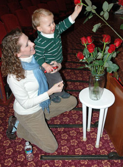 St. John the Evangelist parishioner Megan Certo of Indianapolis helps her son, Peter, place a rose in a vase in memory of the more than 50 million unborn babies who have died in abortion since it was legalized by the U.S.&nbsp;Supreme Court on Jan. 22, 1973. David and Megan Certo are expecting their second child in June. (Photo by Mary Ann Wyand) 