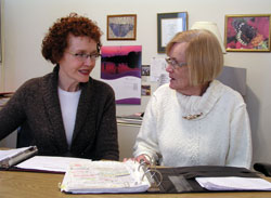 Teresa Hildebrand, left, talks with Barbara Buti about some of the people who have sought help from the Good Samaritan Program at St. Joseph University Parish in Terre Haute. The two women are part of the parish&rsquo;s longstanding commitment to serve the poor and other people in need. (Photo by John Shaughnessy) 
