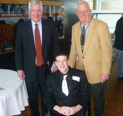 Gavin Provost, center, is pictured with Patrick McCaskey, co-owner of the Chicago Bears, left, and Dick Dornbos, who serves on Sports Faith International&rsquo;s (SFI) advisory board. Provost received the Spirit of Saint Paul Award at Halas Hall on Feb. 21, and was inducted into the SFI High School Hall of Fame. (Photo by Karen Clifford)