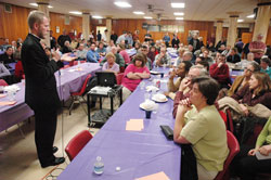 Father Tadeusz Pacholczyk, director of education at the Philadelphia-based National Catholic Bioethics Center, speaks on stem cell research and cloning to a standing-room only crowd of nearly 350 people on March 11 at Our&nbsp;Lady of the Most Holy Rosary Parish in Indianapolis. The presentation took place two days after President&nbsp;Barack Obama issued an executive order that allows federal funding of embryonic stem-cell research. (Photo by Sean Gallagher) 