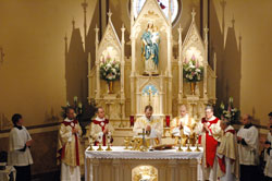 Father Jonathan Meyer, administrator of St. Joseph and St. Anne parishes in Jennings County, celebrates Mass on March 19, the feast of St. Joseph, in the newly restored St. Joseph Church. Concelebrants are, from left, Father Paul Etienne, pastor of St. John the Evangelist Parish in Indianapolis; Father Michael Fritsch, pastor of St. John the Apostle Parish in Bloomington; Father James Meade, pastor of St. Patrick Parish in Chesterton, Ind., in the Gary Diocese, and Father&nbsp;Joseph Sheets, a retired diocesan priest. Deacon John Hollowell, standing to the right of Father&nbsp;Meyer, assisted with the liturgy. (Photo by Mary Ann Wyand) 