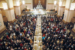 Priests process into SS. Peter and Paul Cathedral in Indianapolis on April 7 for the archdiocese&rsquo;s chrism Mass. Catholics from across the archdiocese filled the cathedral for the annual liturgy during which oils are blessed and priests renew the promises made at their ordination. (Photo by Sean Gallagher) 