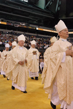Cardinal Francis E. George of Chicago confirms Alisha Webber, a member of Holy Family Parish in Oldenburg, during the May&nbsp;3 Mass at Lucas Oil Stadium in Indianapolis that celebrated the 175th anniversary of the Archdiocese of Indianapolis. (Photo by Sean Gallagher) 