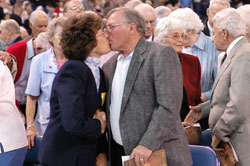 James and Pauline Petroviak of Lawrenceburg share a kiss for the sign of peace during the archdiocese&rsquo;s 175th anniversary Mass on May 3 at Lucas Oil Stadium in Indianapolis. They are members of St. Teresa Benedicta of the Cross Parish in Bright. Nearly 200 couples married for 50 years or more received a nuptial blessing from Archbishop Daniel M. Buechlein during the historic liturgy. (Photo by Mary Ann Wyand) 