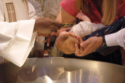 Sacramental preparation offers unique opportunities for individuals, couples and families to reconnect with their faith in new ways. As parents prepare for their child&rsquo;s baptism, first reconciliation and first Communion, they receive a refresher course in the teachings of the Catholic Church and often become more active in practicing their faith. (Photo by Sean Gallagher) 