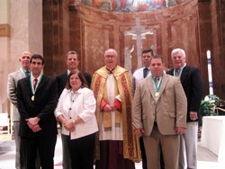 St. John Bosco Award winners from Indianapolis pose for a photograph with Msgr. Joseph F. Schaedel, vicar general, during the Catholic Youth Organization awards ceremony on May 6 at SS. Peter and Paul Cathedral in Indianapolis. They are, from left, Dr. Mark Bohnert of Nativity of Our Lord Jesus Christ Parish, Dr. James Rea of St. Pius X Parish, Jeff&nbsp;Taylor of St. Jude Parish, Kathy Caito of St. Lawrence Parish, Dave Goddard of St. Michael the Archangel Parish, Jerry Deery of Our Lady of Lourdes Parish and Bill Roberts of St. Luke the Evangelist Parish. (Photo by John Shaughnessy) 