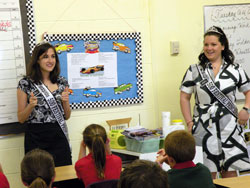 Elizabeth Wheatley, left, and Lindsey Fitzgerald, both 2009 500 Festival princesses, quiz fourth-grade students at St.&nbsp;Matthew School in Indianapolis about race day trivia. The princesses, who both attended Catholic schools, visit schools, hospitals and nursing homes to promote the Indianapolis 500. (Photo by Kamilla Benko) 