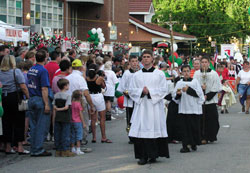 In this file photo taken on June 14, 2004, seminarian Sean Danda of St. Malachy Parish in Brownsburg leads the Marian procession along Stevens Street to Our Lady of the Most Holy Rosary Church in Indianapolis during the &ldquo;Italian Street Festival.&rdquo; Deacon Danda will be ordained to the priesthood by Archbishop Daniel M. Buechlein on June 27 at SS. Peter and Paul Cathedral in Indianapolis. (File photo by Mary Ann Wyand) 