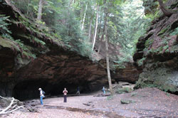 Hikers admire the massive rock formations at Turkey Run State Park near Marshall in scenic Parke County. The temperature is considerably cooler while walking in the rocky ravines that date back to prehistoric times. (File photo by Mary Ann Wyand)