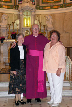 Standing with Msgr. Joseph F. Schaedel, vicar general, in the Blessed Sacrament Chapel at SS. Peter and Paul Cathedral in Indianapolis on May 14 are Paula Slinger, left, and Darlene Cole, right, the most recent graduates of the archdiocese&rsquo;s Ecclesial&nbsp;Lay Ministry formation program. (Photo by Kamilla Benko) 