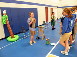 Avalin Senefeld, left, impersonates Gene&nbsp;Stratton-Porter, the author of A Girl of the Limberlost, during the St. Luke School Wax&nbsp;Museum on May 14. Fourth-grade students researched Indiana historical figures and presented two-minute speeches about their lives while students and parents listened. (Photo by Kamilla Benko)