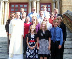 Deacon John Hollowell poses at left in the second row with his family&nbsp;and other relatives on Oct. 25, 2008, on the steps of the Archabbey Church of Our Lady of Einseideln in St. Meinrad. Posing with him are, first row, from left, Maria, Laura and Nathan Hollowell; second row, from left, grandmother Jeanette, Emily, Sara and mother Diane&nbsp;Hollowell; third row, from left, sister-in-law Kari, Melissa and Danny Hollowell, and aunt and godmother Cindy Huff; and fourth row, from left, Tony, Aaron, Matt and father Joseph Hollowell. (Submitted photo) 