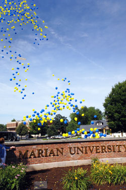 Blue and yellow balloons are released on June 27 on the campus of Marian College in Indianapolis to celebrate its name change from Marian College to Marian University. Daniel Elsener, the school’s president, recently announced that it had received a $6 million gift from a former trustee, a record individual gift for Marian. (Photo courtesy of Marian University)