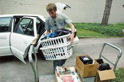 Archdiocesan seminarian Daniel Bedel, a senior at Bishop Simon Brut&eacute; College Seminary in Indianapolis, unloads his car on Aug. 13 at the seminary. Many of the 23 seminarians at Bishop Brut&eacute; moved in that day while construction workers made renovations to add 10 additional bedrooms to the seminary. (Photo by Sean Gallagher)