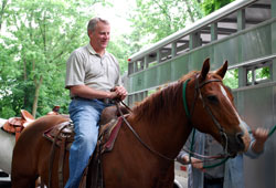 Marian University President Daniel Elsener gets ready to take a horse ride on the Indianapolis campus this summer&mdash;part of his preparation to fulfill a promise he made to the university&rsquo;s football players. Elsener told the team he would ride a horse and lead them onto the field when the university&rsquo;s new sports stadium officially opens on Sept. 19. (Submitted photo) 