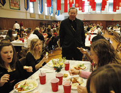 Archbishop Daniel M. Buechlein talks with Catholic high school students during a luncheon in April honoring student leaders in the A&nbsp;Promise to Keep: God&rsquo;s Gift of Human Sexuality program. In the archdiocesan program, Catholic high school students pledge to follow a life of chastity and share that message with students in the junior-high age group in Catholic grade schools. The archdiocese is expanding its chastity education program to involve parents and educators. (File photo by Mary Ann Wyand) 
