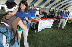 Fellowship of Catholic University Students missionary Anne Marie Brummer, right, explains a survey given to an Indiana University-Purdue University Indianapolis student during an activities fair held on Sept. 1 on the school&rsquo;s campus. Standing behind Brummer are FOCUS missionaries Alexandra Kale, left, and Matthew Johnson. (Photo by Sean Gallagher)