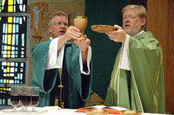 Deacon Michael Stratman, left, assists Father Rick Ginther during an Aug. 9 Mass at St. Margaret Mary Church in Terre Haute. Ordained on June 28, 2008, as a member of the first class of permanent deacons in the history of the Archdiocese of Indianapolis, Deacon Stratman ministers at St. Margaret Mary and St.&nbsp;Patrick parishes in Terre Haute, where Father Ginther serves as pastor. (Photo by Sean Gallagher) 