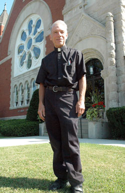 Father William Turner, pastor of St. Mary (Immaculate Conception) Parish in Rushville, stands in front of his parish&rsquo;s church on Sept. 16. Ordained in 1975, Father Turner has ministered in Catholic high schools and parishes across the archdiocese. (Photo by Sean Gallagher) 
