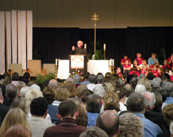 Jesuit Father Fred&nbsp;Kammer delivers a keynote address to the more than 600&nbsp;participants at the &ldquo;Spreading Hope in Neighborhoods Everywhere&rdquo; conference on Oct.&nbsp;1 in Indianapolis. The priest encouraged participants, in their ministry of charity, to do everything with the love of God in their heart and the look of love on their face. (Photo by Brandon A. Evans) 