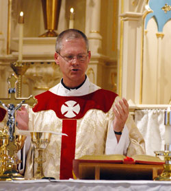Then-Father Paul Etienne prays part of the eucharistic prayer during a March 19 Mass at St.&nbsp;Joseph Church in Jennings County. The Mass celebrated the completion of the restoration of the church, where Father Etienne once served as a sacramental minister. (File photo by Mary Ann Wyand) 