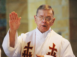 Retired Father Henry Brown prays the eucharistic prayer during a May 11, 2006, Mass at St. Paul Hermitage in Beech Grove. Father&nbsp;Brown, who died on June 21, 2009, became a resident at the Hermitage in 1998, and soon became known for his tireless ministry to his fellow residents who were close to death. (File photo by Sean Gallagher)