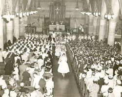 Girls process out of Our Lady of Lourdes Church in May 1955 at the conclusion of a May crowning ceremony in the parish situated in the heart of Irvington, a historic neighborhood on Indianapolis&rsquo; east side. (Submitted photo) 