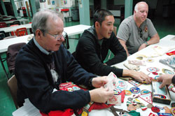 St. Michael the Archangel parishioners Phil Price, from left, his son, William, and Jim Cowden, all of Indianapolis, reminisce about Catholic Scouting during a meeting on Oct. 1 at St. Michael School in Indianapolis. Current and former members of St. Michael Parish&rsquo;s Boy Scout Troop #400 will celebrate 50 years of continuous Scouting on Nov. 7. (Photo by Mary Ann Wyand) 