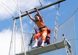 High above the ground, 13-year-old Irene Velicer begins to swing on the trapeze&mdash;part of an unusual and breathtaking physical education class at St. Charles Borromeo School in Bloomington. (Photo by John Shaughnessy)