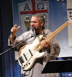 Franciscan Friars of the Renewal Father Stan Fortuna of Bronx, N.Y., performs a song during the fourth annual Indiana Catholic Men&rsquo;s Conference on Oct. 17 at the Indiana Convention Center in Indianapolis. He urged the 950 participants to &ldquo;man up&rdquo; and accept their responsibilities as Christians. (Photo by Mary Ann Wyand)