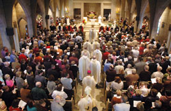 Members of St. Paul Parish in Tell City fill their parish church on Nov. 1 at the start of a Mass to celebrate the faith community&rsquo;s 150th anniversary as Archbishop Daniel M. Buechlein, Bishop-designate Paul D. Etienne, St. Paul&rsquo;s pastor, and other priests who have ministered at the parish process into the church. (Photo by Sean Gallagher)