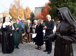 Providence Sister Susan Paweski, left, portrays St. Theodora Gu&eacute;rin during the closing of the inaugural St. Mother Theodore Gu&eacute;rin Fest at Saint Mary-of-the-Woods on Oct. 25. She is flanked to the right by Providence Sister Barbara Doherty, chairperson of the planning committee. At right is Providence Sister Denise Wilkinson, general superior, and Pierre Vimont, French ambassador to the United States. In the foreground is the recently dedicated statue of St. Theodora. The statue, a recent addition to the sister&rsquo;s campus, was dedicated on June 28. (Submitted photo) 