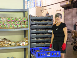 Society of St. Vincent de Paul volunteer Barbara Sherrow, a member of St. Jude Parish in Indianapolis, works the bread portion of the society&rsquo;s Client Choice Food Pantry in Indianapolis. (Submitted photo) 