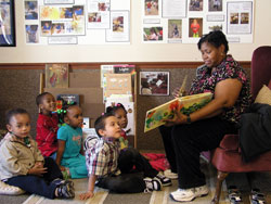 Educator Pat Hughes reads to 3-, 4- and 5-year-old children at St. Mary&rsquo;s Child Center in Indianapolis, which is affiliated with the archdiocesan Secretariat for Catholic Education and Faith Formation. The center offers an early childhood education that its staff believes can improve the lives of at-risk children. (Photo by John Shaughnessy)