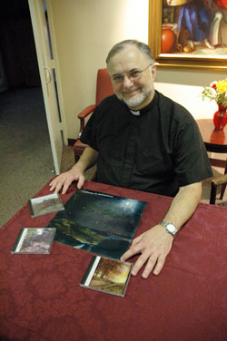 Father James Farrell, the director of Our Lady of Fatima Retreat House in Indianapolis, poses for a photograph on Dec. 2 with his &ldquo;Pathways to Prayer&rdquo; series of guided meditation CDs. (Photo by Mary Ann Wyand)