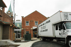 Movers with Two Men and a Truck carry furnishings into the new Holy Family Shelter on Nov. 19, which was the 25th anniversary of the opening of the first Holy Family Shelter at 30 E. Palmer St. on the near south side in Indianapolis. The new shelter is located at 907 N. Holmes Ave. next to Holy&nbsp;Trinity Church on the near west side in Indianapolis. (Photo by Mary Ann Wyand)