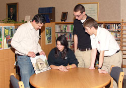 David Marsee, left, talks with Jenna Kolb, Joe Linginfelter and Joel Stocksdale, all juniors at Seton Catholic High School in Richmond, about a watercolor painting that he created of St. Mary Church in Richmond on the occasion of the parish&rsquo;s recent 150th anniversary. Marsee is a member of St. Andrew Parish in Richmond, and volunteers at Seton Catholic High School. (Photos by James Stephenson)