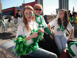 Providence Sister James Michael Kesterson wore a touch of the green and a smile that wouldn&rsquo;t quit during this year&rsquo;s St. Patrick&rsquo;s Day Parade on March 17 in Indianapolis. The principal of St. Jude School in Indianapolis rode in a convertible during the parade. She is flanked by two students, Taylor Mattingly, left, and Nichole Smith. (Submitted photo)