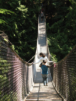 St. Luke the Evangelist parishioners Gabriella Benko, 12, and Matthias Benko, 8, of Indianapolis navigate one of Lynn Canyon Park&rsquo;s famous suspension bridges. The swaying bridge hangs 20 stories above Lynn Creek. Children love it. (Photo by Kamilla Benko)