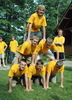 Several campers make a human pyramid during the 2008 Bishop Brut&eacute; Days, a vocations camp and retreat experience sponsored by Bishop Simon Brut&eacute; College Seminary in Indianapolis. The camplers are, from left, bottom row, Joe Linginfelter, Marshall&nbsp;Tobin and Vincent Jansen, and middle row, Byron Woods and Joseph Cole. On the top is Patrick Lockhart. Seminarian Tim&nbsp;Wyciskalla looks on from behind. Jansen and Cole are expected to be freshmen at Bishop Brut&eacute; in August. (File photo by Sean Gallagher)