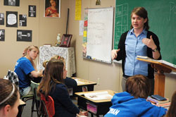 Jennifer Prickel teaches a seventh-grade religion&nbsp;class on March&nbsp;10 at St.&nbsp;Nicholas School in Ripley County. Prickle, who desires to enter the Steubenville, Ohio-based Sisters of Reparation to the Most&nbsp;Sacred Heart of Jesus, is being held back from responding to her vocation to religious life by student loan debt. (Photo by Sean Gallagher)