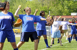 Softball players from Roncalli High School in Indianapolis and John Marshall Community High School in Indianapolis practice together on May 4. The special connection that has developed between the two teams once again shows &ldquo;the amazing power of God,&rdquo; according to a Roncalli softball coach. (Photo by Alan Petersime/The Indianapolis Star)