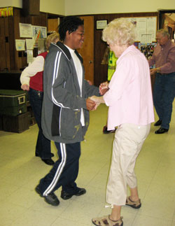 Kevin Thacker dances with an unidentified woman at a senior citizens center in Copperhill, Tenn., one of the ways that eighth-grade students from Holy Cross Central School in Indianapolis connected with people during a mission trip there this spring. (Submitted photo)
