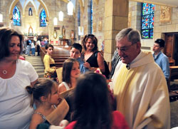 Members of St. Mary Parish in Lanesville surround their now-retired pastor, Father&nbsp;Harold Ripperger, after a May 17, 2008, Mass at the parish church that celebrated the 50th anniversary of his priestly ordination. Chuck and Leslie Lynch, members of St.&nbsp;Mary Parish, credit their former pastor with building up a strong culture of stewardship in the New Albany Deanery faith community. (Submitted photo)