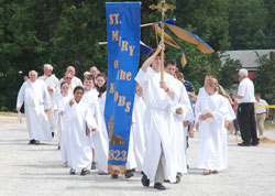 Altar servers, priests and members of St. Mary-of-the-Knobs Parish in Floyd County process to a groundbreaking ceremony on June 27 at the site where the New Albany Deanery faith community&rsquo;s new church will be constructed. (Submitted photo by Elaine Davis)