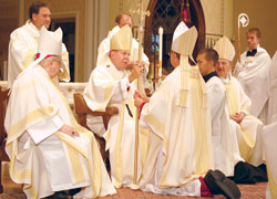 Newly ordained Bishop&nbsp;Timothy L.&nbsp;Doherty of Lafayette receives his crosier from Archbishop Daniel M.&nbsp;Buechlein of Indianapolis during the July&nbsp;15 episcopal ordination and installation liturgy at the Cathedral of St.&nbsp;Mary of the Immaculate Conception in Lafayette, Ind. (Photo by Caroline Mooney/The Catholic Moment)