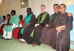 Franciscan Father Michael Perry, third&nbsp;from right, and two other members of the General&nbsp;Curia of the Order of Franciscan Minors visit the area of Omdurman, Khartoum, Sudan, in early July. The priests concelebrated Mass at a small Christian community center. More than 350 people attended the celebration. (Submitted photo)